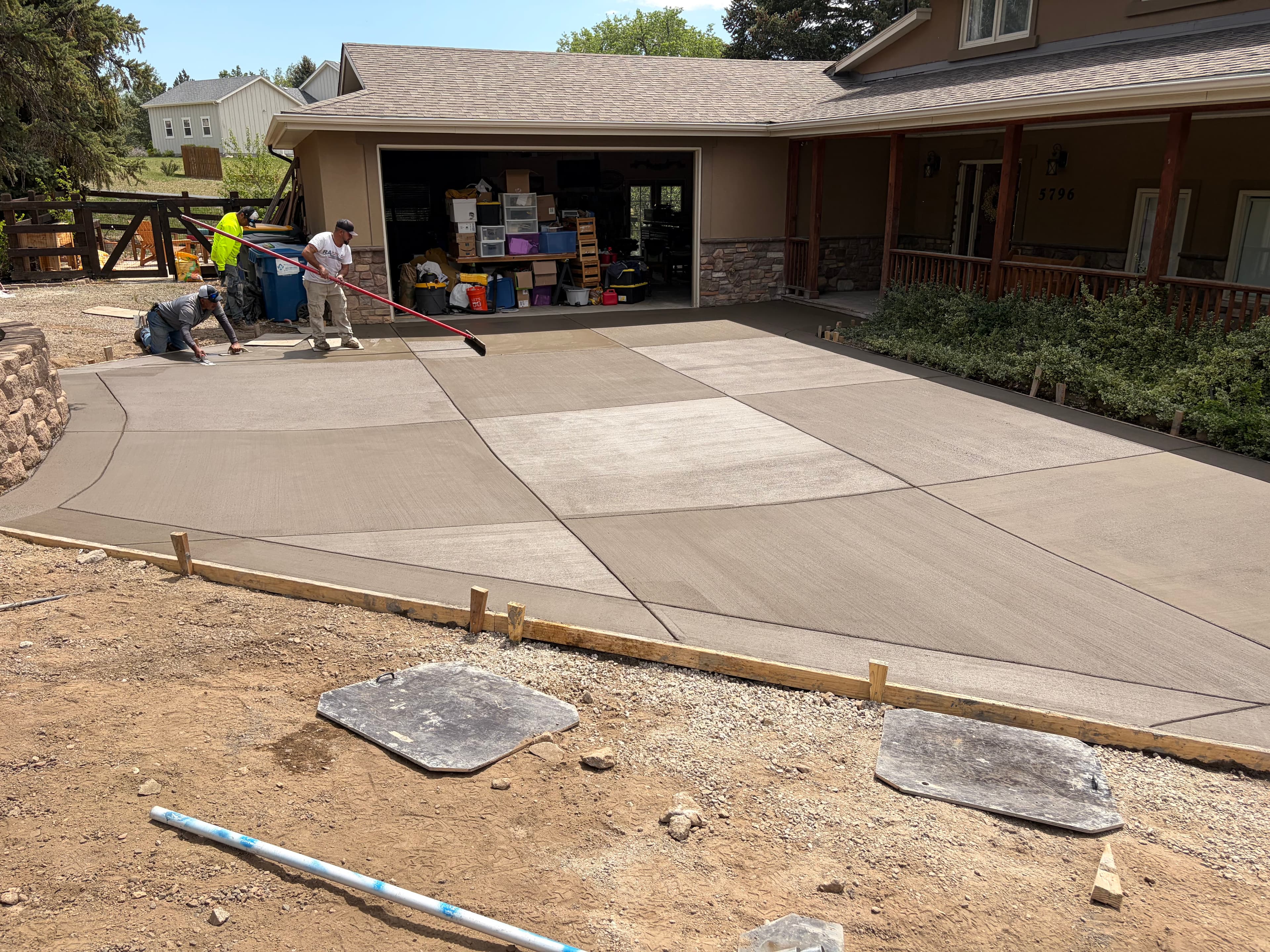 JGH crew finishing a freshly poured concrete driveway