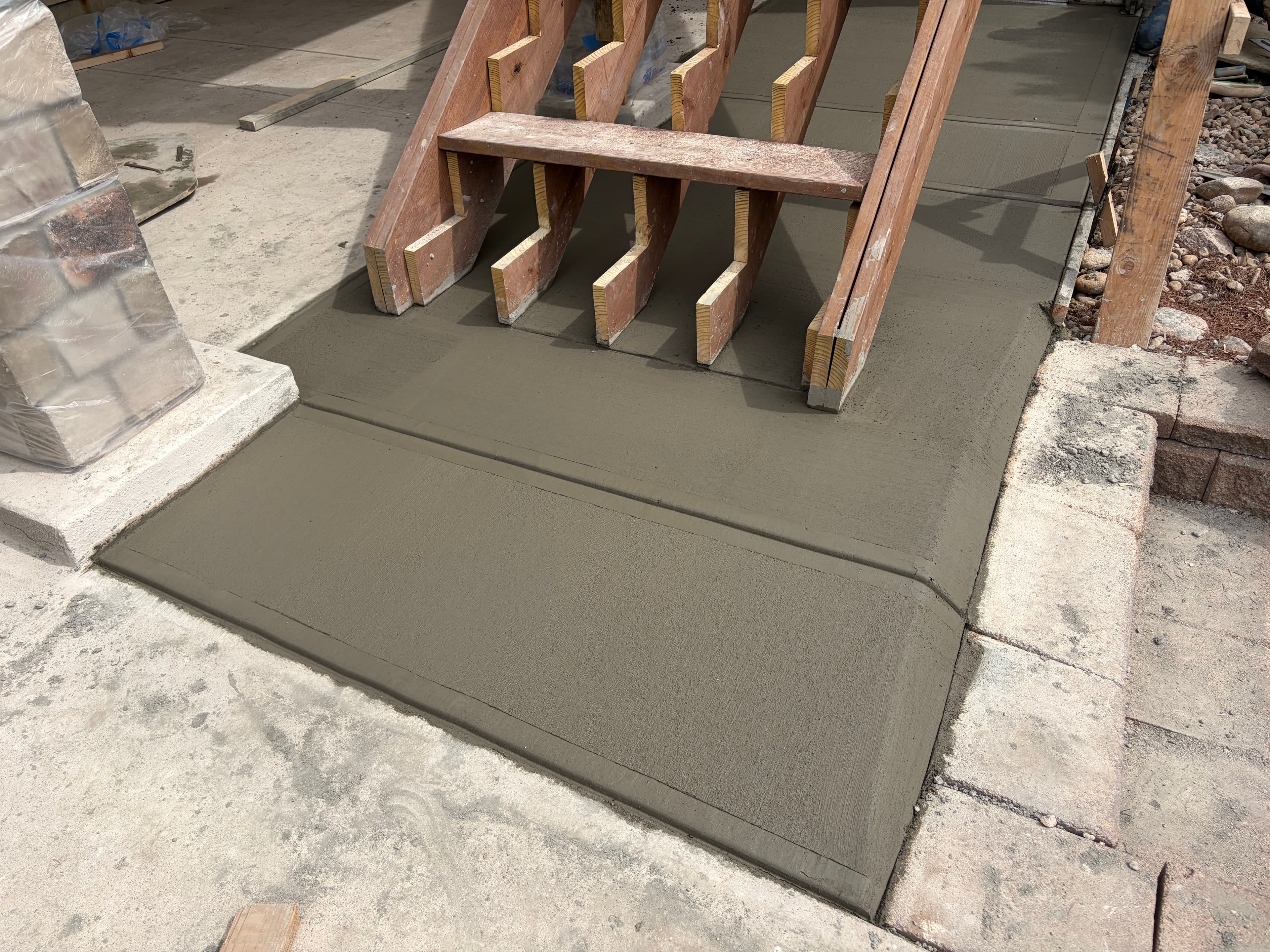 Concrete steps freshly poured in wood forms